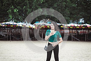 Confident asian woman using mobile phone on the beach,Happy and smiling,Relax time,Summer travel concept