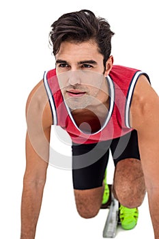 Confident athlete man in ready to run position