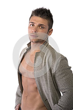 Confident, attractive young man with open jacket on muscular torso