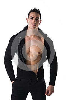 Confident, attractive young man with open sweater on muscular torso