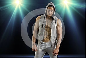 Confident, attractive young man with open vest on