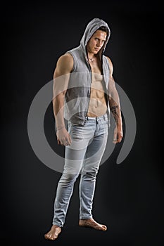 Confident, attractive young man with open vest on