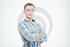 Confident attractive young man standing with arms crossed