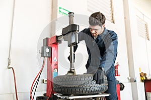 Auto Expert Using Tire Changer Machine At Repair Shop