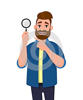 Confident bearded man holding magnifying glass and pointing hand finger towards. Search, find, discovery, analyze, inspect.