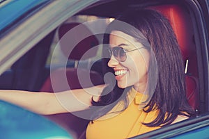 Confident and beautiful. Attractive woman in yellow dress in her new modern car