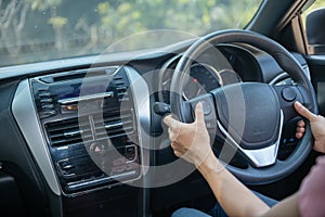 Confident and beautiful. Rear view of attractive young woman in casual wear looking over her shoulder while driving a car. girl