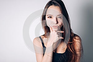 Confident beautiful woman looking directly at the camera. Portrait of a young girl.