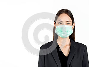 A confident beautiful young Asian business woman wearing green medical face mask and black suit