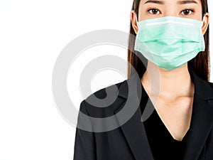 A confident beautiful young Asian business woman wearing green medical face mask and black suit