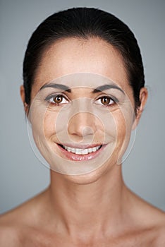 Confident beauty. Cropped studio portrait of a beautiful mature woman smiling.