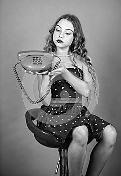 Confident beauty. pinup girl happy conversation. kid sit on chair dial phone. communication concept. retro style