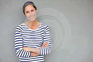 Confident beauty. Portrait of an attractive mature woman in casualwear standing against a gray wall.