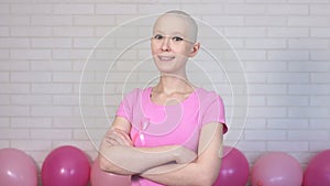 Confident breast cancer survivor woman looking crosses her arms looking at the camera and smiling - breast cancer