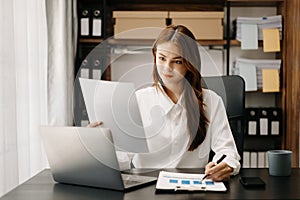 Confident business expert attractive smiling young woman holding digital tablet on desk in creative office