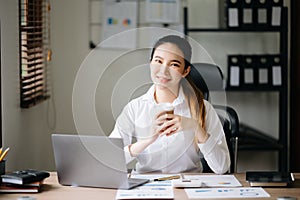 Confident business expert attractive smiling young woman holding digital tablet on desk in creative office