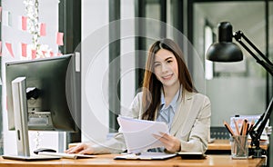 Confident business expert attractive smiling young woman holding digital tablet on desk in office
