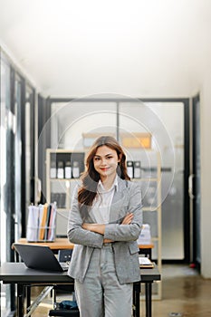 Confident business expert attractive smiling young woman holding digital tablet on desk in office