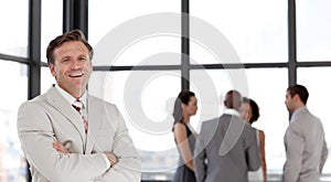 Confident business man in font of business team