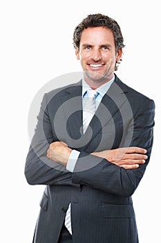 Confident business man smiling. Portrait of successful business man with hands folded on white background.