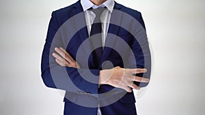 Confident business man walking into focus area, arms crossed on white background