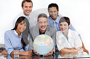 Confident business partners holding a globe