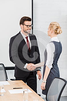 confident business partners shaking hands