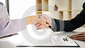 Confident business people shaking hands, Employer hires and shakes the applicant hand after the job interview