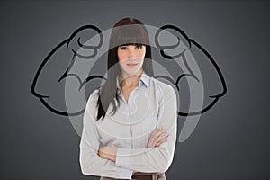 Confident business woman against grey background with drawing of flexing muscles