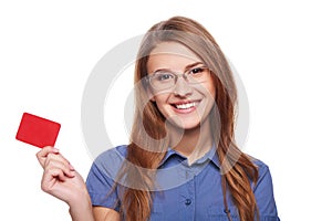 Confident business woman in glasses showing blank credit card