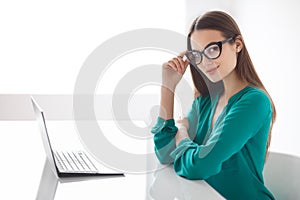 Confident business woman with laptop in the office