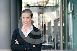 Confident business woman smiling with arms crossed