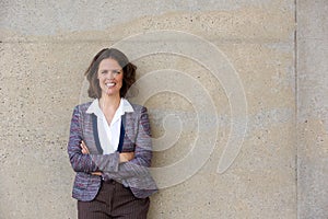 Confident business woman smiling with arms crossed