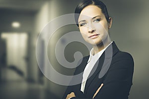 Confident business woman smiling with arms crossed