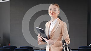 Confident business woman smiling at camera in office workspace. Independent female executive enjoying successful