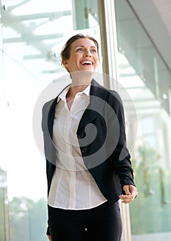 Confident business woman smiling and walking outside