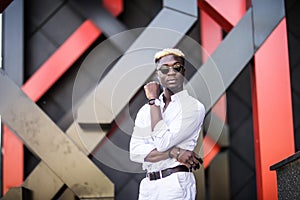 Confident businessman. Confident young afro american man standing outdoors with modern city in the background