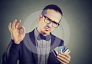 Confident businessman with credit cards