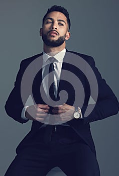 Confident businessman, fashion and suit in formal attire or clothing on a dark studio background. Handsome man, young