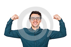 Confident businessman flexing muscles imagine superpower. Nerd guy wears eyeglasses shows his strength, positive face expression,