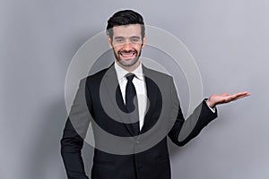 Confident businessman in formal suit making hand gesture. Fervent