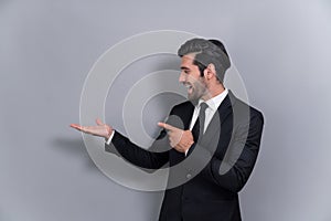 Confident businessman in formal suit pointing finger and hand. Fervent