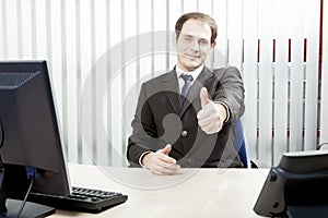 Confident businessman giving a thumbs up