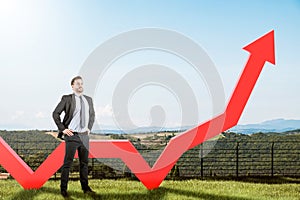 Confident businessman and growing graph