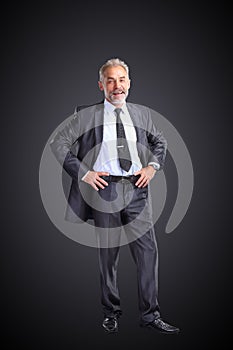 confident businessman holding hands on his belt