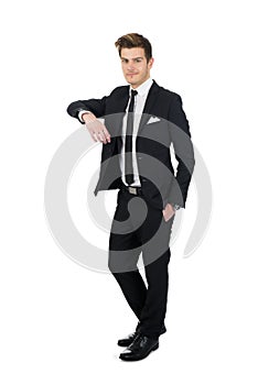 Confident businessman leaning on invisible wall