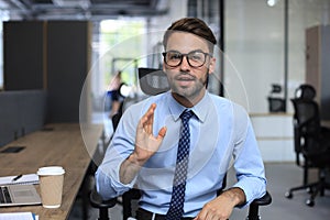 Confident businessman looking at camera talking about company strategy and business plan, explaining corporate success