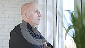 Confident Businessman Looking on the Window in Office Room Waiting Pensive a Business Meeting