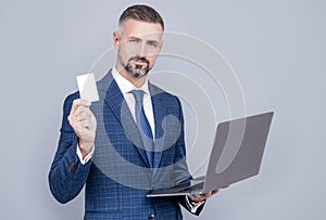 confident businessman man in businesslike suit hold laptop and debit card, shopping online