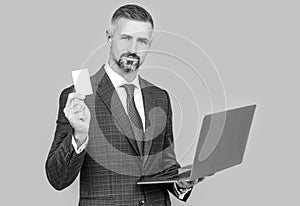 confident businessman man in businesslike suit hold laptop and debit card, shopping online